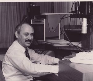 Photo of Dr. Samuel Genensky sitting at a computer
