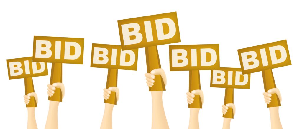 A group of hands holding signs. The signs say bid, bid, bid.